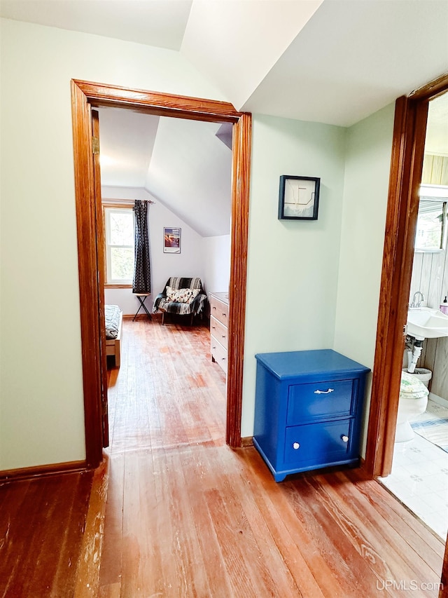 812 Spruce St, Marquette, MI 49855 - hallway featuring wood finished floors, vaulted ceiling, and baseboards