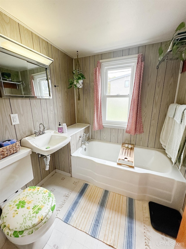 812 Spruce St, Marquette, MI 49855 - full bath featuring toilet, a garden tub, wooden walls, and a sink