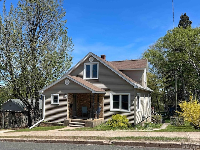 812 Spruce St, Marquette, MI 49855 - view of front of home featuring a chimney, a porch, and a shingled roof