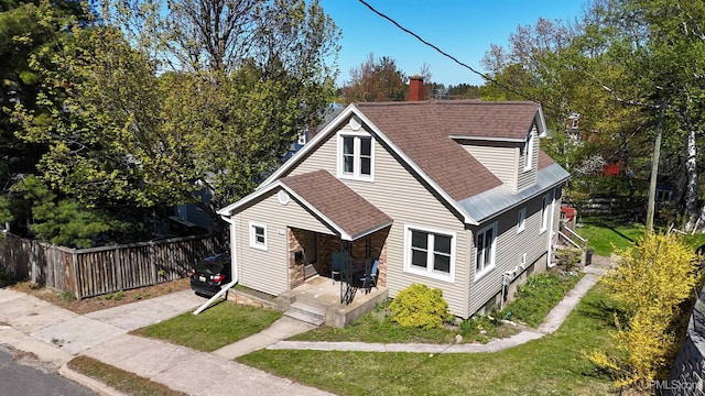 812 Spruce St, Marquette, MI 49855 - bungalow-style house featuring roof with shingles, a chimney, and a porch