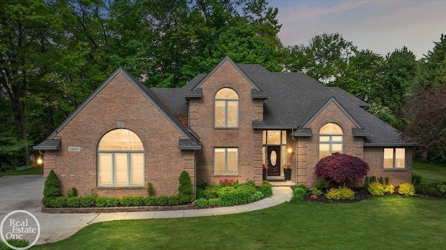 63011 Indian Hills Dr Unit # 1, Washington Twp, MI 48095 - traditional home featuring brick siding, a lawn, and roof with shingles