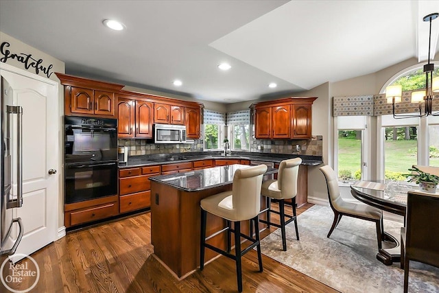 63011 Indian Hills Dr Unit # 1, Washington Twp, MI 48095 - kitchen featuring black appliances, a sink, healthy amount of natural light, tasteful backsplash, and recessed lighting