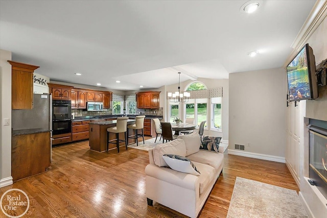 63011 Indian Hills Dr Unit # 1, Washington Twp, MI 48095 - living area featuring wood finished floors, baseboards, a chandelier, and recessed lighting