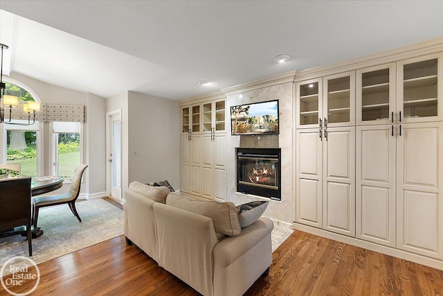 63011 Indian Hills Dr Unit # 1, Washington Twp, MI 48095 - living room with wood finished floors, lofted ceiling, a large fireplace, baseboards, and recessed lighting