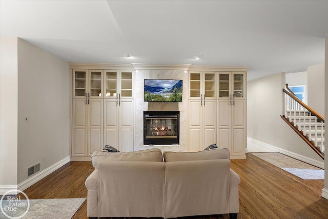 63011 Indian Hills Dr Unit # 1, Washington Twp, MI 48095 - living room featuring baseboards, a large fireplace, wood finished floors, and stairs