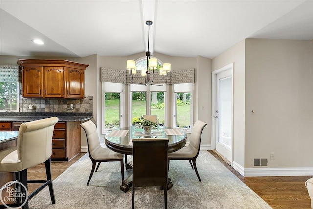 63011 Indian Hills Dr Unit # 1, Washington Twp, MI 48095 - dining area featuring a chandelier, light wood-style floors, and baseboards