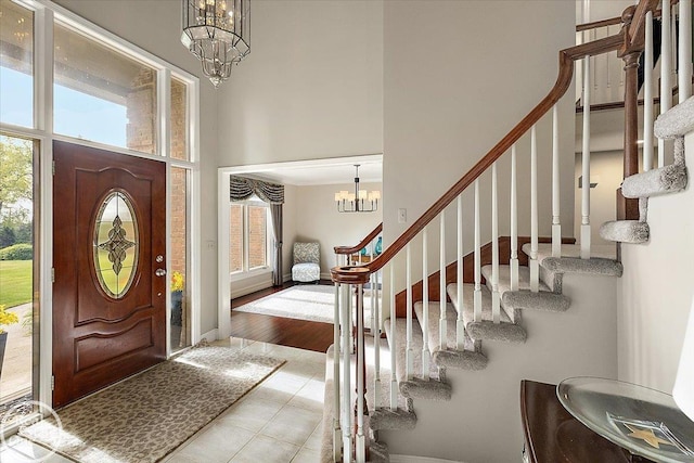 63011 Indian Hills Dr Unit # 1, Washington Twp, MI 48095 - entryway featuring a chandelier, a high ceiling, stairway, and tile patterned flooring
