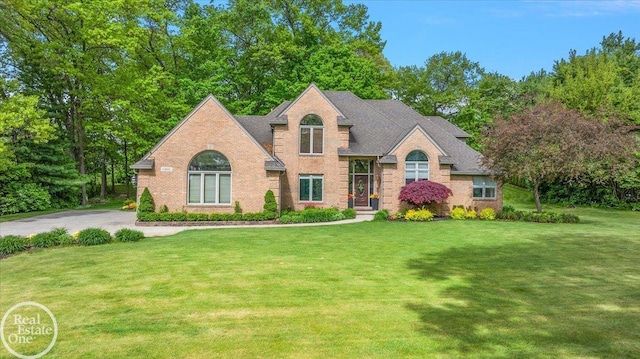 63011 Indian Hills Dr Unit # 1, Washington Twp, MI 48095 - view of front of home featuring brick siding and a front lawn