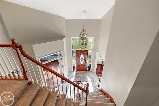 63011 Indian Hills Dr Unit # 1, Washington Twp, MI 48095 - foyer featuring a towering ceiling, a chandelier, and stairway