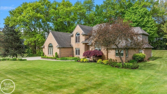 63011 Indian Hills Dr Unit # 1, Washington Twp, MI 48095 - view of front of property featuring a front lawn, brick siding, and roof with shingles