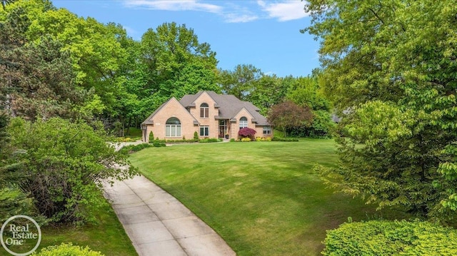 63011 Indian Hills Dr Unit # 1, Washington Twp, MI 48095 - french country style house with a front yard and brick siding