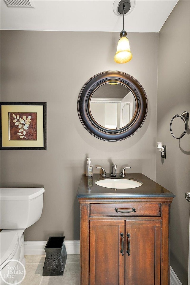 63011 Indian Hills Dr Unit # 1, Washington Twp, MI 48095 - bathroom featuring vanity, toilet, baseboards, and tile patterned floors