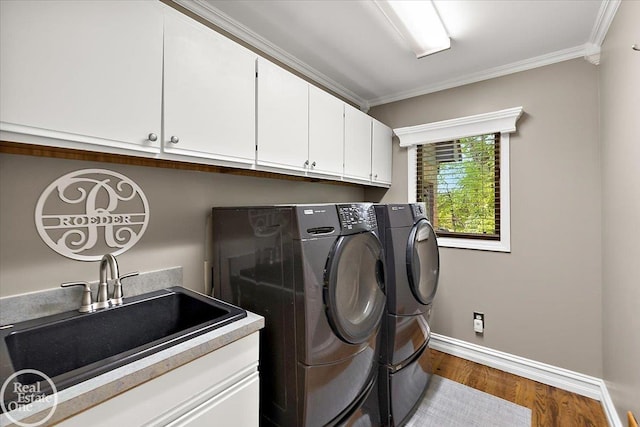 63011 Indian Hills Dr Unit # 1, Washington Twp, MI 48095 - laundry room featuring independent washer and dryer, ornamental molding, cabinet space, wood finished floors, and baseboards