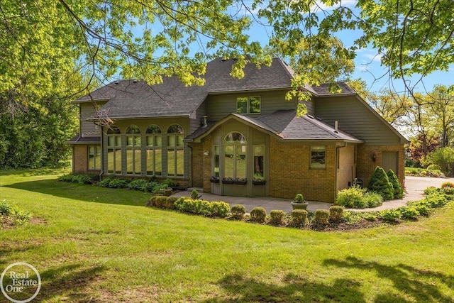 63011 Indian Hills Dr Unit # 1, Washington Twp, MI 48095 - view of front facade with brick siding, a front lawn, and a shingled roof