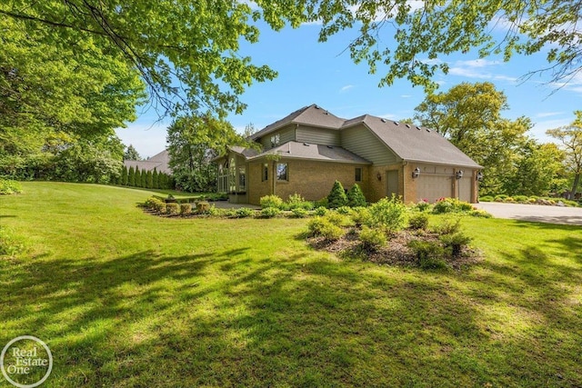 63011 Indian Hills Dr Unit # 1, Washington Twp, MI 48095 - view of home's exterior featuring a garage, a yard, driveway, and brick siding