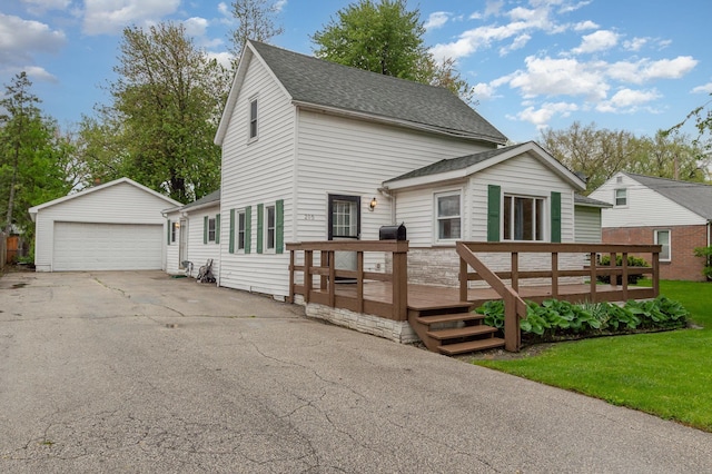 205 E Murphy St, Bay City, MI 48706 - view of front of home featuring a garage, a deck, an outdoor structure, roof with shingles, and a front yard