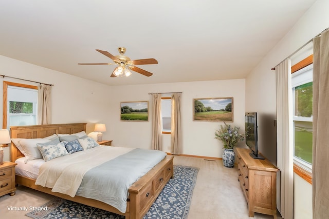 205 E Murphy St, Bay City, MI 48706 - bedroom with light colored carpet, ceiling fan, and baseboards