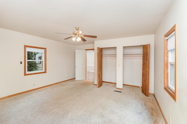 205 E Murphy St, Bay City, MI 48706 - unfurnished bedroom with multiple closets, light colored carpet, and baseboards