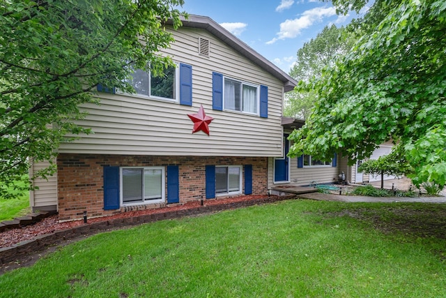 4719 Myra Lee Dr, Auburn, MI 48611 - view of front of house with a front yard and brick siding