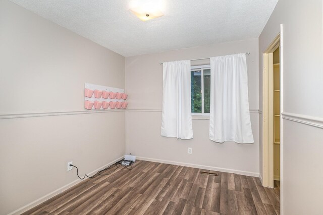 4719 Myra Lee Dr, Auburn, MI 48611 - unfurnished bedroom featuring wood finished floors, baseboards, and a textured ceiling