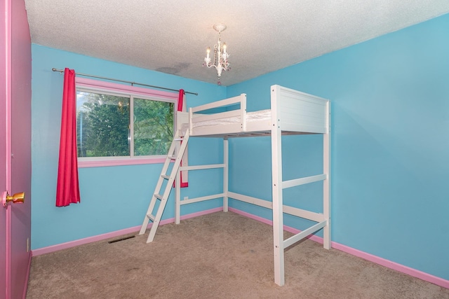 4719 Myra Lee Dr, Auburn, MI 48611 - unfurnished bedroom featuring carpet flooring, a chandelier, a textured ceiling, and baseboards