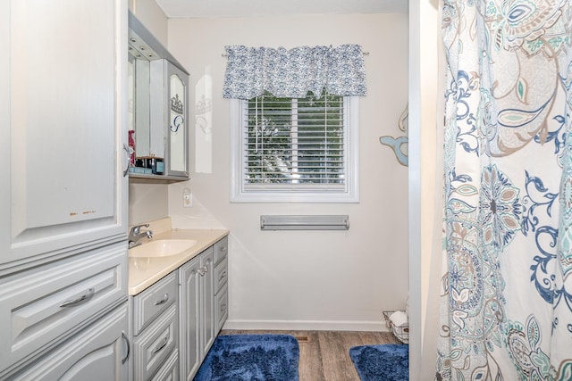 4719 Myra Lee Dr, Auburn, MI 48611 - full bathroom featuring vanity, wood finished floors, and baseboards