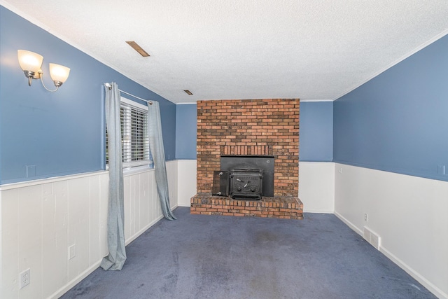 4719 Myra Lee Dr, Auburn, MI 48611 - unfurnished living room featuring a wood stove, a textured ceiling, and carpet floors