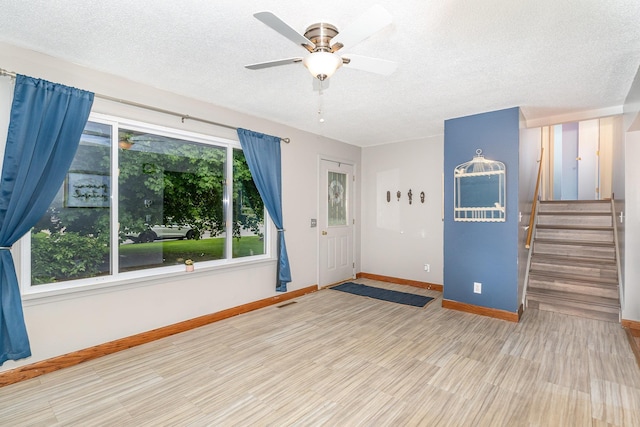 4719 Myra Lee Dr, Auburn, MI 48611 - foyer with baseboards, a textured ceiling, stairway, ceiling fan, and wood finished floors