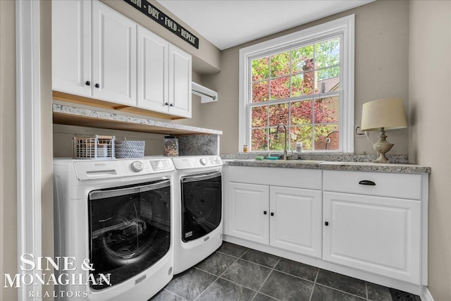 55266 Lordona Ln, Shelby Twp, MI 48315 - washroom featuring independent washer and dryer, cabinet space, and dark tile patterned floors
