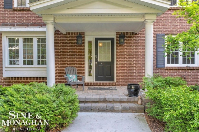 55266 Lordona Ln, Shelby Twp, MI 48315 - doorway to property featuring brick siding and covered porch