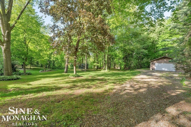 55266 Lordona Ln, Shelby Twp, MI 48315 - view of grassy yard featuring an outdoor structure and a garage