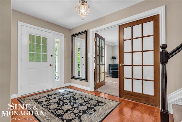 55266 Lordona Ln, Shelby Twp, MI 48315 - foyer entrance with light wood-type flooring, baseboards, and a chandelier