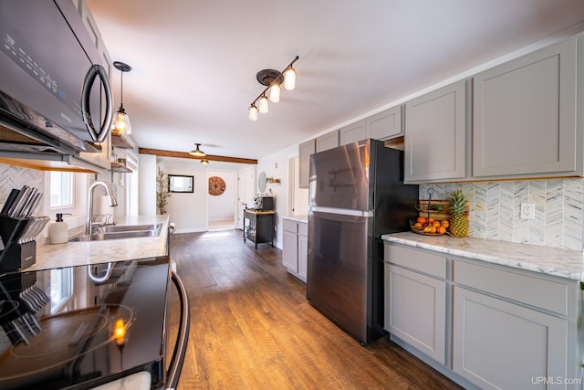 2091 Wilkinson Ave, Marquette, MI 49855 - kitchen featuring freestanding refrigerator, a sink, gray cabinetry, decorative backsplash, and wood finished floors