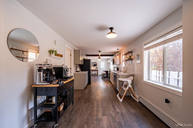 2091 Wilkinson Ave, Marquette, MI 49855 - kitchen featuring light countertops, dark wood-style floors, a baseboard radiator, ceiling fan, and a sink