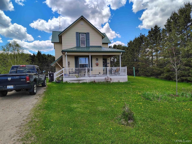 4203 E Maple Ridge 37th Rd, Rock, MI 49880 - view of front of house with covered porch, a front yard, and metal roof