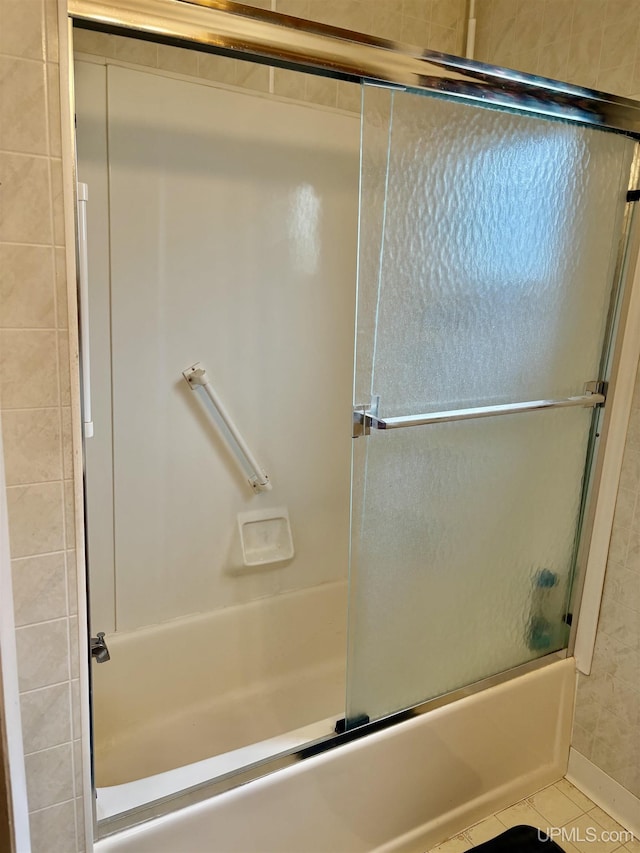 215 Day St, Ironwood, MI 49938 - bathroom featuring tile patterned floors and combined bath / shower with glass door