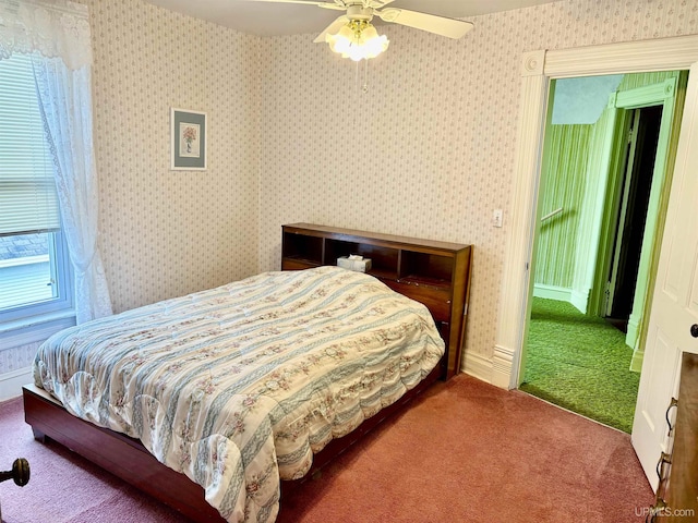215 Day St, Ironwood, MI 49938 - bedroom with carpet flooring, wallpapered walls, and ceiling fan
