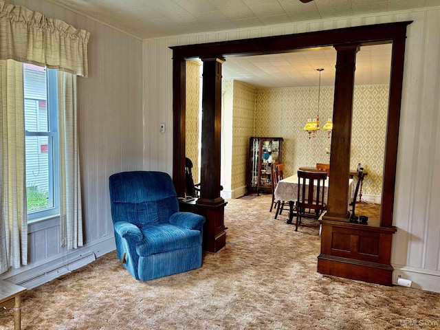 215 Day St, Ironwood, MI 49938 - sitting room featuring decorative columns, a baseboard heating unit, carpet flooring, and a chandelier