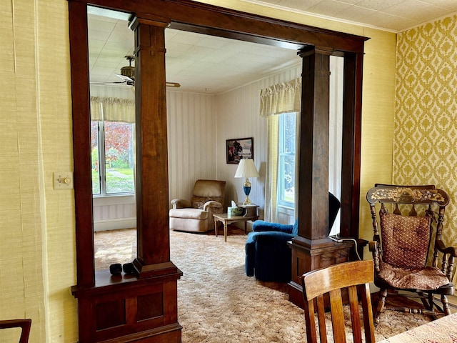215 Day St, Ironwood, MI 49938 - living area featuring ornamental molding, wallpapered walls, decorative columns, and carpet flooring