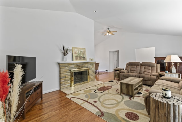 42910 Utica Rd, Sterling Heights, MI 48314 - living area featuring ceiling fan, a brick fireplace, wood finished floors, baseboards, and high vaulted ceiling