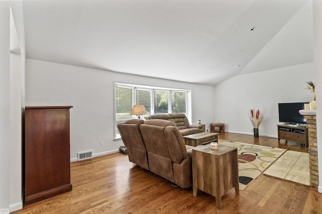 42910 Utica Rd, Sterling Heights, MI 48314 - living room with wood finished floors, vaulted ceiling, and baseboards