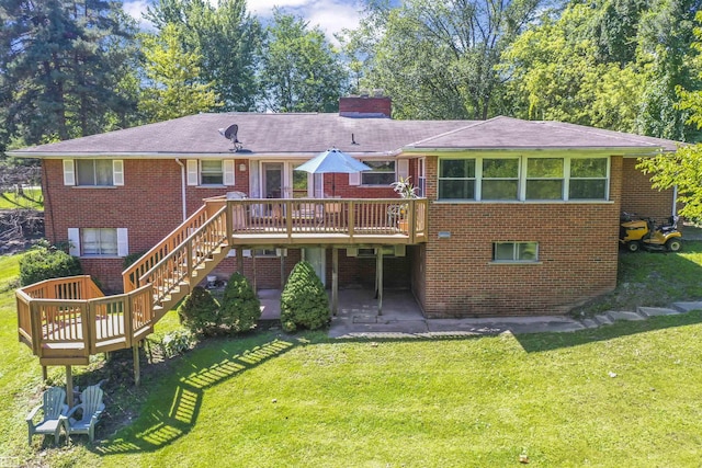 42910 Utica Rd, Sterling Heights, MI 48314 - rear view of property featuring a deck, brick siding, a chimney, and a yard