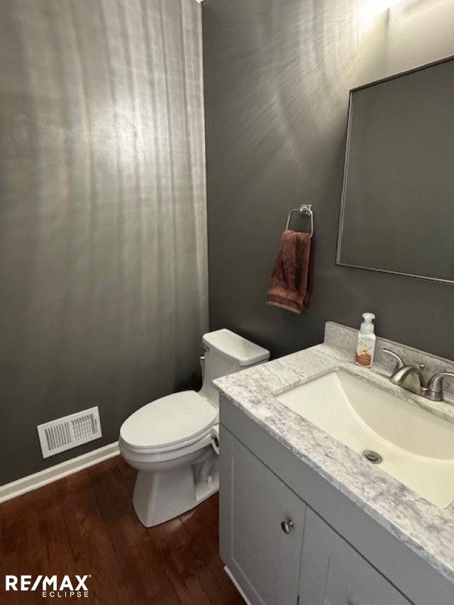 53234 Fox Pointe Dr, New Baltimore, MI 48047 - bathroom with vanity, wood finished floors, and toilet