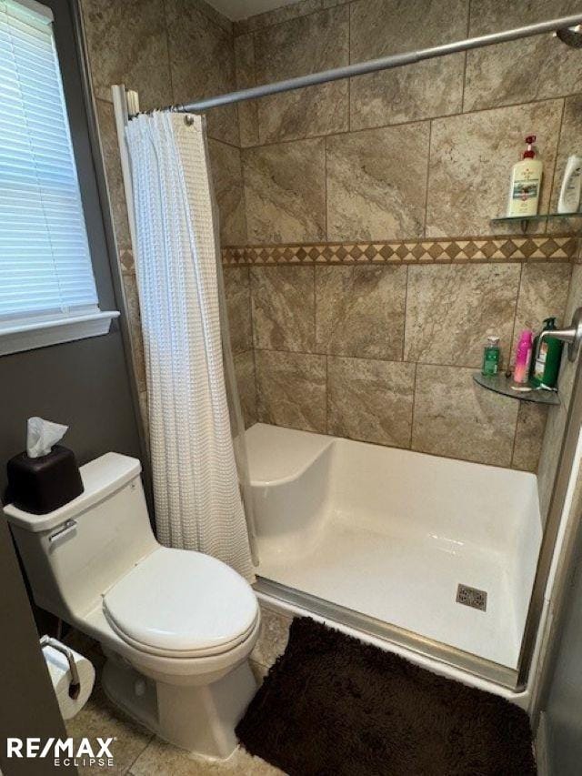 53234 Fox Pointe Dr, New Baltimore, MI 48047 - bathroom with a shower stall, toilet, and tile patterned flooring