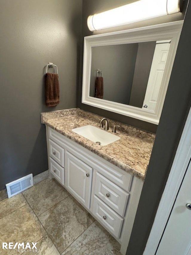 53234 Fox Pointe Dr, New Baltimore, MI 48047 - bathroom featuring vanity, tile patterned flooring, and baseboards