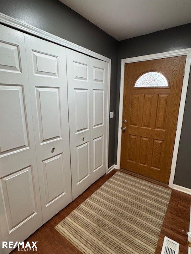 53234 Fox Pointe Dr, New Baltimore, MI 48047 - entrance foyer with dark wood-style floors and baseboards