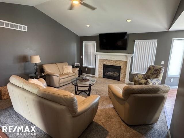 53234 Fox Pointe Dr, New Baltimore, MI 48047 - living area featuring vaulted ceiling, a ceiling fan, a glass covered fireplace, recessed lighting, and baseboards