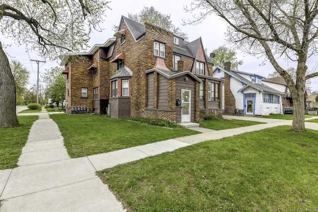 1104 Minnie St, Port Huron, MI 48060 - view of front of property featuring brick siding and a front yard