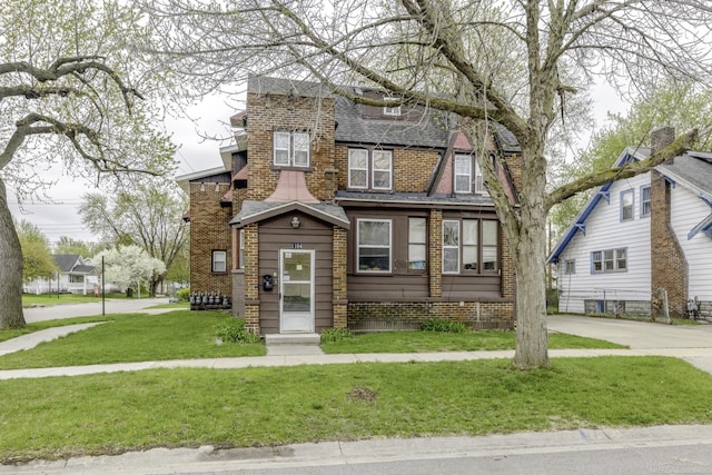1104 Minnie St, Port Huron, MI 48060 - view of front of house with a front yard, brick siding, and roof with shingles