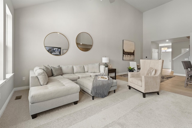 2215 Chase Dr Unit 102, Howell, MI 48855 - carpeted living room featuring high vaulted ceiling and baseboards